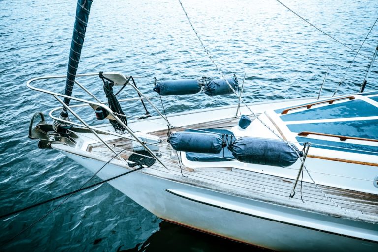 white and black boat on sea during daytime